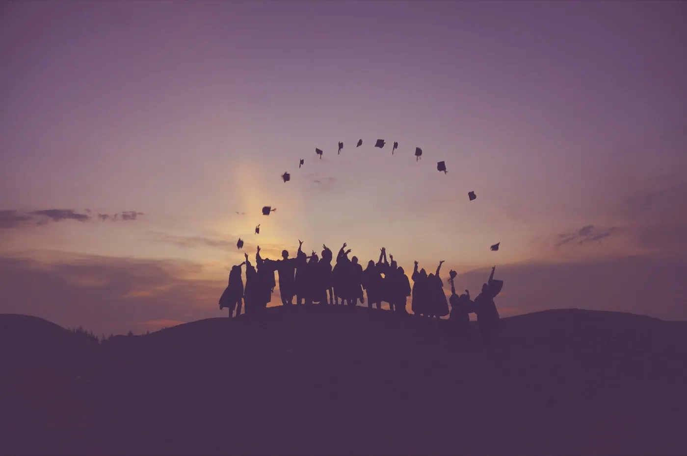 Graduates celebrating in caps and gowns